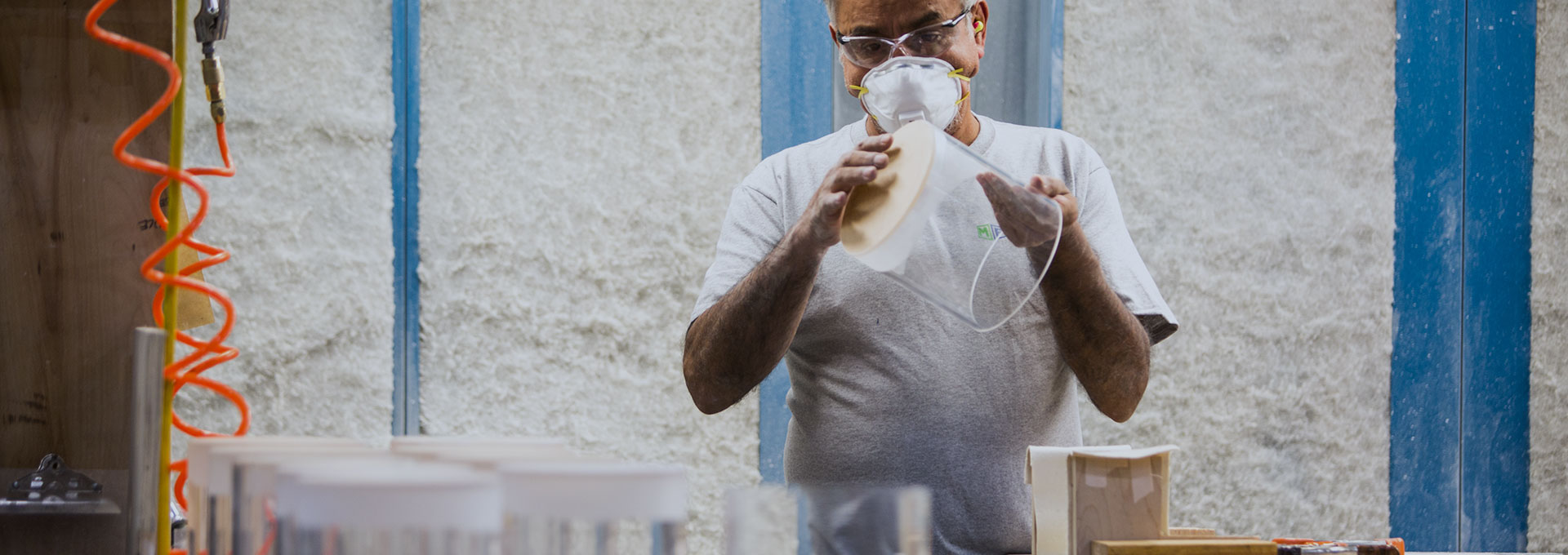 worker using chemical welding on a clear cylinder product